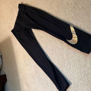 Black Womens medium Nike leggings with gold swish